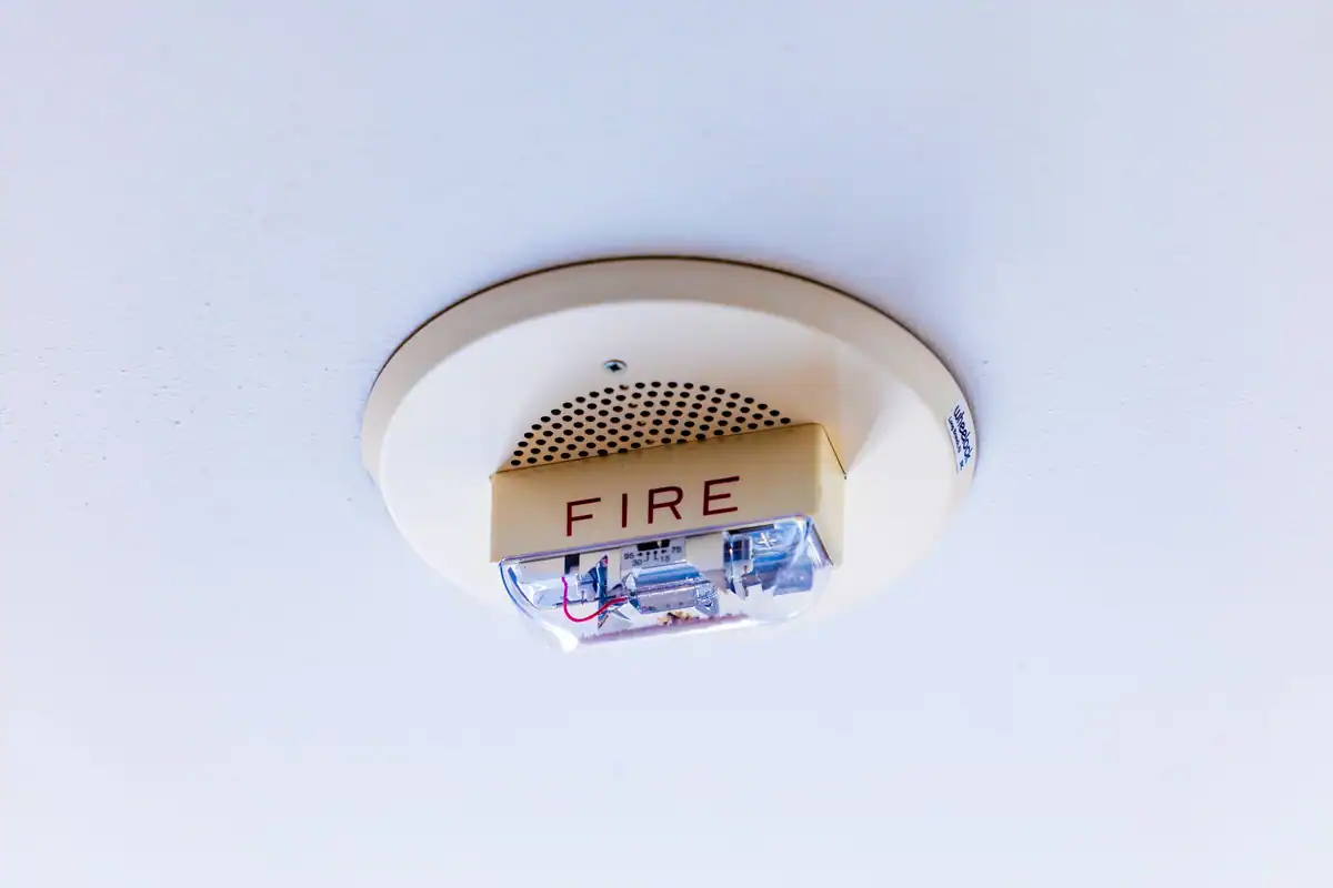 Detector montat pe tavanul unei camere, care avertizează la apariția fumului